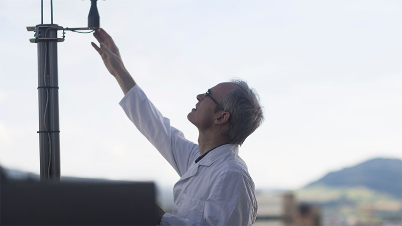 Meteorologist measuring wind speed – accurate data triggers make parametric insurance payouts fast and reliable.
