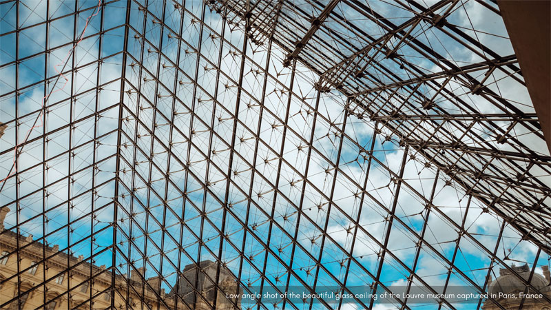 Low angle shot of the beautify glass ceiling of the Louvre museum captured in Paris, France